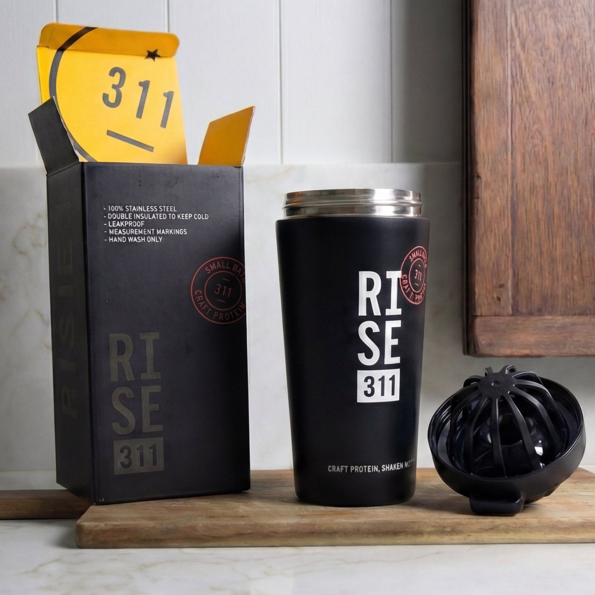 RISE 311 shaker in box with yellow inside, shaker and blender ball in a wood and marble kitchen