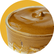 Yellow circular icon with rise protein shake in a glass on a yellow background.
