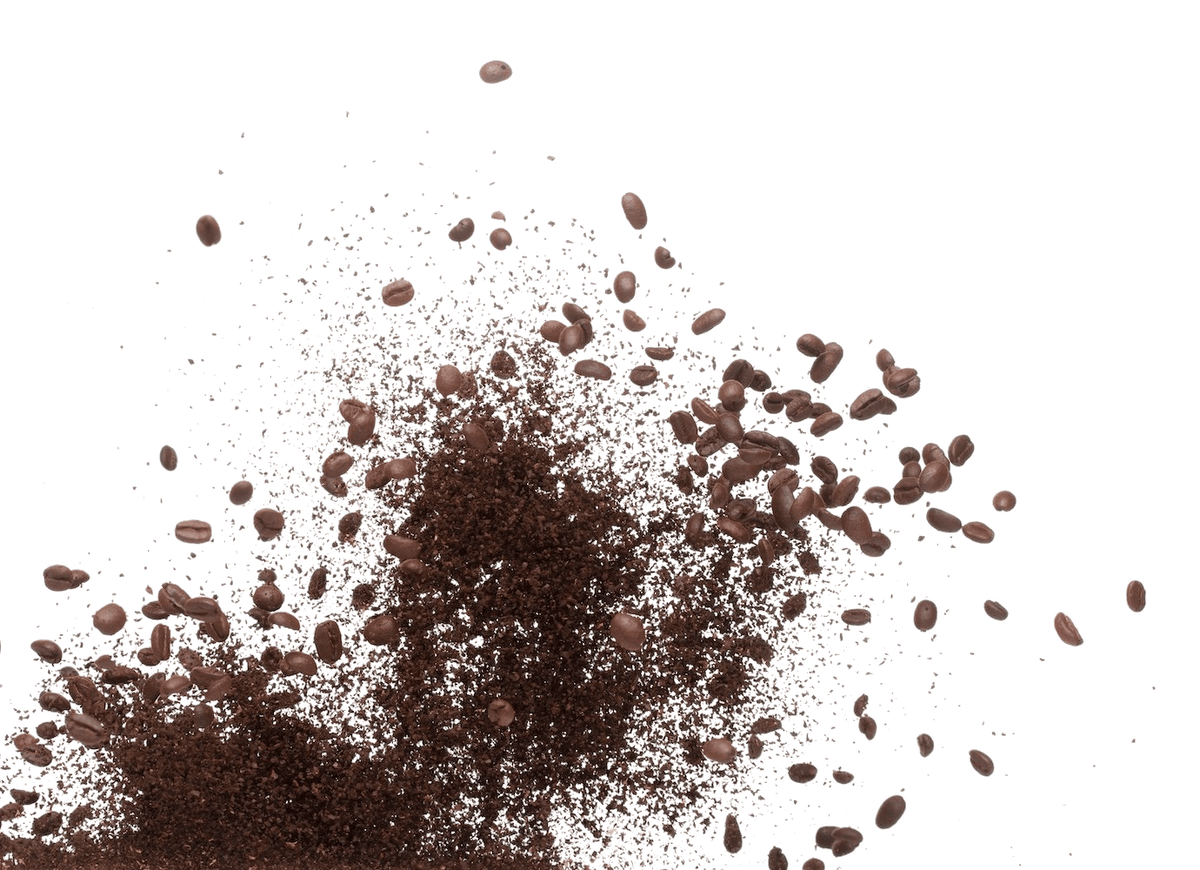 Coffee beans and ground coffee powder exploding upwards.
