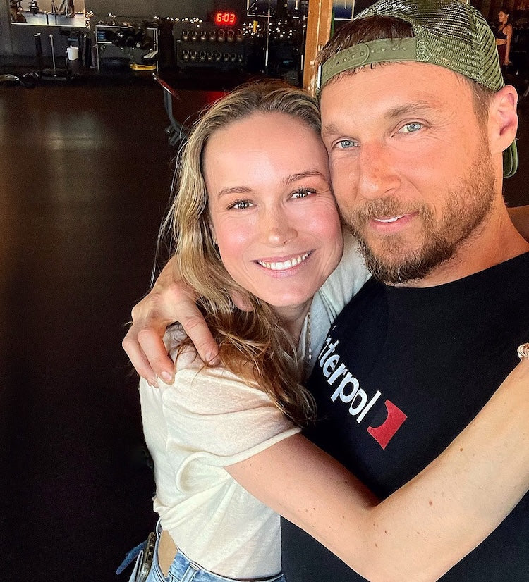 Jason Walsh and Brie Larson posing together at the gym