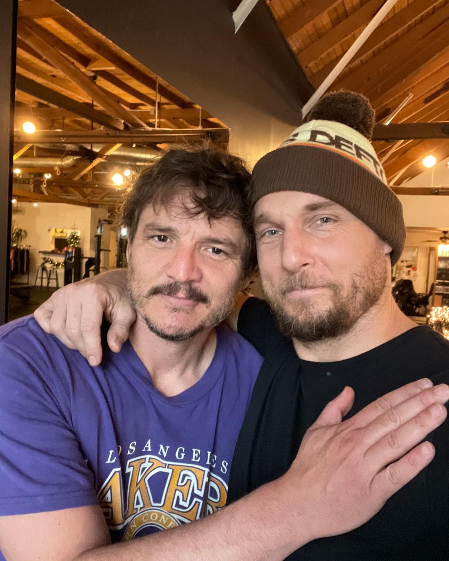 Pedro Pascal and Jason Walsh gym selfie in warm lighting