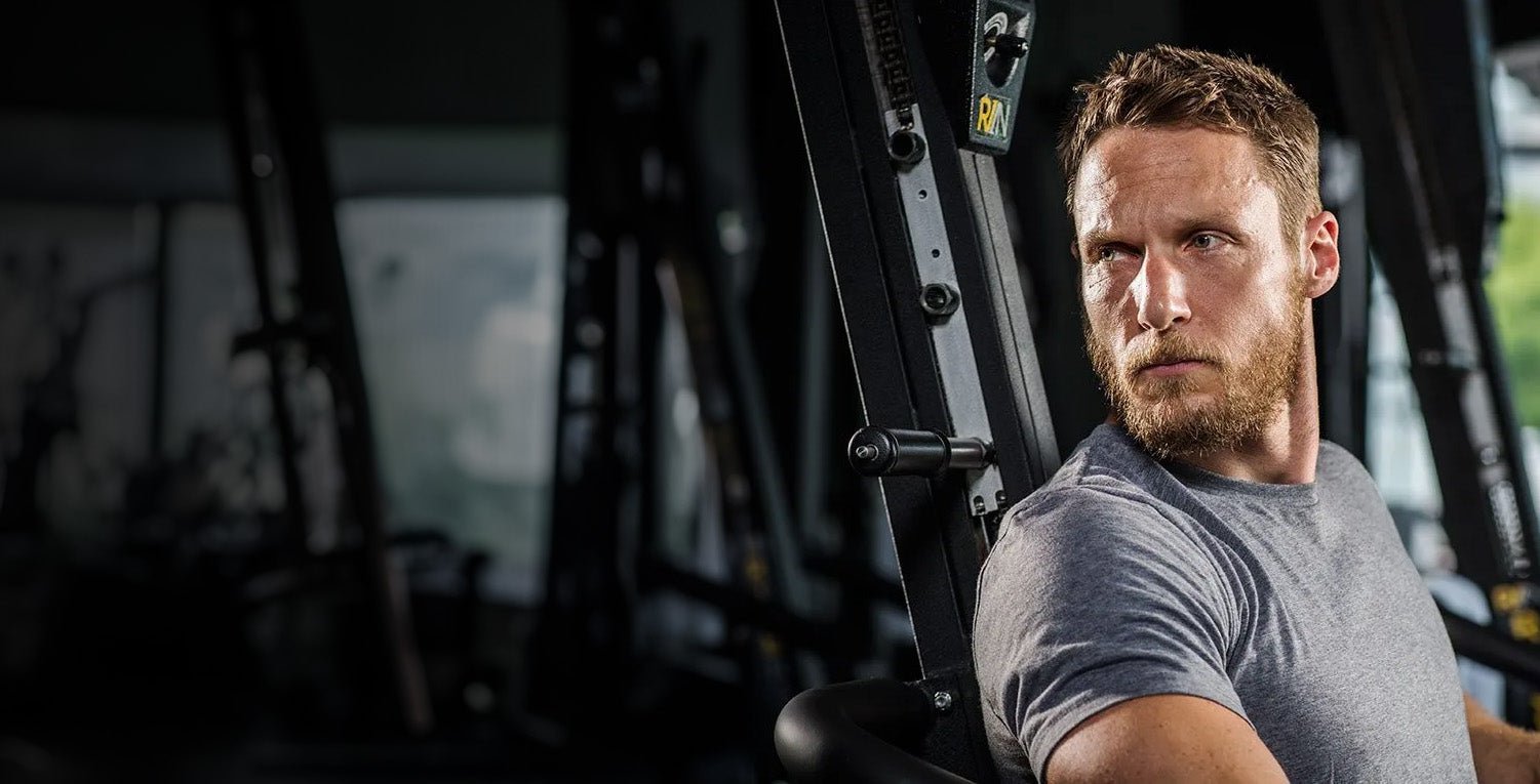 RISE311 founder Jason Walsh in gym with training equipment in background